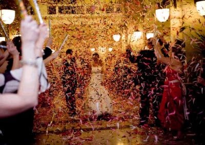 Bride and groom leaving through confetti